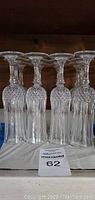 Set of 12 clear full lead Yugoslavian crystal glasses with cut diamond and vertical line pattern, shown arranged in rows.