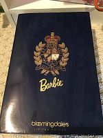 Closed box showing navy blue color with gold Ralph Lauren crest and Barbie and Bloomingdales logos