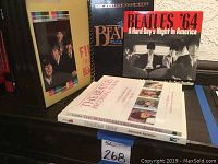 Photo showing six Beatles books arranged upright and lying down, including titles such as Beatles '64 and The Beatles Recording Sessions.