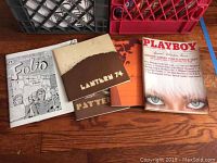 Photo of two vintage magazines 'Foto' and 'Lantern 74' alongside a Playboy issue with a close-up face on cover.