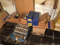 Overview of lot: multiple Getty hinge boxes, a mortise lock box, toolbox with mixed hardware