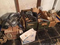 Overview photo showing boxed and loose hardware including brackets and nails beside power tools.