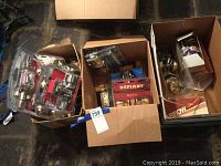 Wide overhead view of three boxes containing door hardware