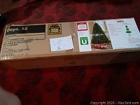 Image of boxed Holiday Time 7.5-FT Non-Lit Donner Fir Christmas Tree with labeling, lot number, and shipping details.