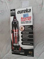 Front view of the Eureka AirSpeed EXACT Pet vacuum box showing product image and features including AirSpeed Technology, Pet Power Paw turbo nozzle, washable dust cup filter, and 3-year warranty.