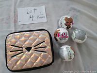 Quilted cat face bag with four LOL Surprise sealed dolls