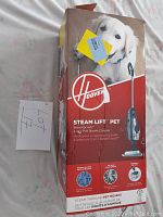 Photo of Hoover SteamScrub SteamLift Pet 2-1qt Pet Steam Cleaner box showing front with dog image and product info.
