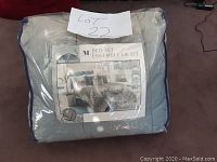 Photo of sealed packaged Riviera Collection 7 piece queen comforter set with label showing floral pattern and grey color.