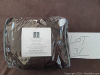 Photo of Distinctly Home Spectrum duvet cover set in original plastic packaging with label and lot number card shown.