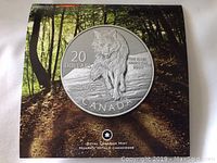 Obverse image of 2013 Canadian $20 silver coin depicting a wolf with inscriptions.