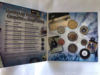 Opened folder showing a list of Stanley Cup victories from 1917 to 1967, and display of multiple coins and medals with Maple Leafs logos and hockey imagery.