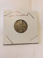 Obverse side showing 20 CENTS 1912 with a laurel wreath around the bottom