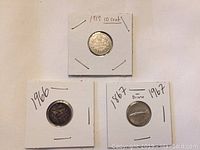 Front view of 1919, 1966, and 1967 Canadian dimes in protective holders, labels visible.