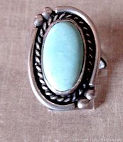 Top view showing oval light blue Sleeping Beauty turquoise cabochon in detailed Navajo sterling silver setting with rope bezel and silver beads.