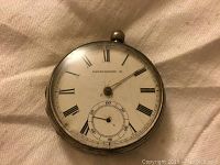 Front view of the pocket watch dial showing Roman numerals, subsidiary seconds dial, and 'Farringdon H' marking