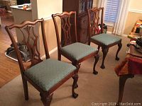 Group of four chairs showing front view, style and upholstery