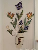 Front showing full ceramic vase with attached metal wire design and ceramic flowers mounted on wall