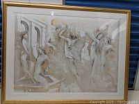 Full view of the framed print showing women bathing in soft neutral tones, with a gold frame and white mat.