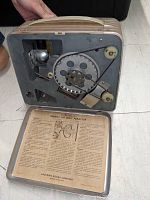 Inside view of vintage Kodascope projector showing internal reel and mechanism with instruction panel from Eastman Kodak Company.