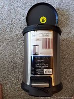 Photo showing front view of the stainless steel step can with label displaying size, capacity, and features