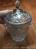 Crystal candy dish held in hand, showing cut patterns, lid, and knob