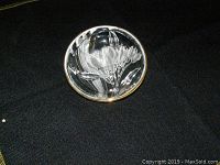 Clear image showing the top of the glass candy dish with a detailed raised flower inside and scalloped edges