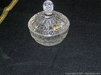 Crystal candy dish with textured patterned bowl and matching lid on black surface