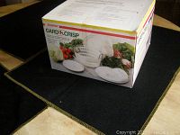 Photo shows the original boxed Starfrit Gard'n Crisp salad spinner, highlighting the product image and branding on the box.