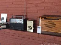Photo showing from left: Sony cassette recorder, Craftsman multi-band radio, Airline transistor radio, and wooden Philco radio.