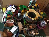 Overview photo showing gardening supplies grouped together including pots, tools, soil bags and chemical bottles