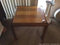 Front view of Lane Virginia wood table showing square top and rounded legs.