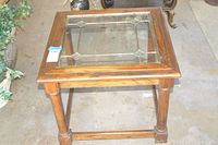 Front top angled view of wooden end table with leaded glass top showing condition and design.
