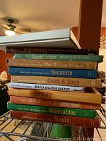 Stack of vintage cookbooks focused on Southern recipes with various food categories