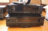 Photo showing Pioneer SX-2700 receiver stacked on Yamaha Natural Sound receiver, Panasonic RP-HT770 headphones on top.
