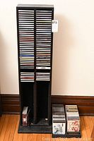 Full view of black composite CD holder filled partially with CDs
