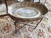Front angle showing the entire tray and the stand on a floral rug, highlighting the ornate tray details and black stand.