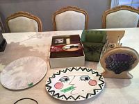 Overview photo showing entire lot including desk set, plant pot, wooden plate holder, and pottery plate and platter.