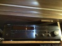 Front view of Yamaha R-V98 stereo receiver showing buttons, display, and volume knob.