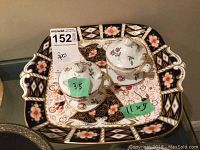 Porcelain tray with floral and geometric patterns, shown with measuring stickers indicating 11x9 inches, also includes salt and pepper shakers on top.