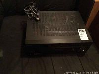 Black Sony STR-DE898 receiver unit with power cord on top.