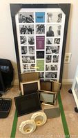 Large collage gallery frame with 24 photo spots and assorted smaller frames arranged below, showing overall contents of the lot.