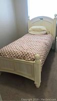 Single kids cannonball bed with pillow and patterned bedding from headboard side view