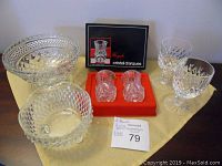 Full view of boxed mini vases, glass bowls and wine glasses on table with seller note