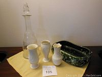 Lot setup showing green Beauceware speckled dish, three Lenox porcelain bud vases, vintage glass decanter with stopper on table.