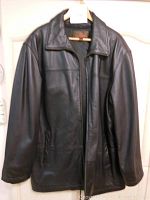 Front view of the black leather men's coat on hanger showing classic collar and front zipper.