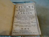 Title page of the book showing the title 'Guerras Civiles de Inglaterra: Tragica Muerte de su Rey Carlos' with ornate border and publication details in Barcelona, 1673.