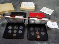 Four open coin cases displaying Canadian coin sets from 1971, 1972, 1974, and 1980 showing multiple coins in each set along with their presentation boxes and certificates.