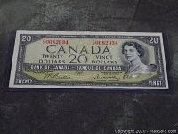 Front of 1954 Canadian $20 bill showing Queen Elizabeth II and serial number 0082934 in protective sleeve.