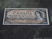 Front of 1954 Canadian $100 banknote in protective sleeve