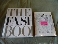 Photo of the covers showing 'The Fashion Book' by Phaidon and 'The Power of Style' by Anna Tapert and Diana Edkins on fabric background.
